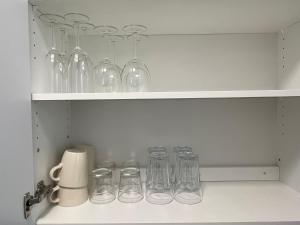 a row of glasses sitting on a shelf at Kotkanlankila in Kotka