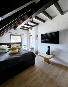 a bedroom with a large bed and a table at Bahnhofsnest in Idar-Oberstein