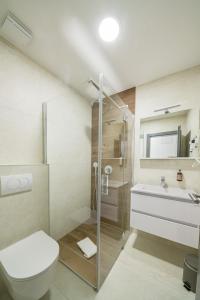 a bathroom with a shower and a toilet and a sink at Restoran Bosiljevo in Bosiljevo