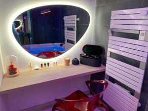a bathroom with a mirror and a red chair at Mont Evasion Spa in Tanis +13 photos