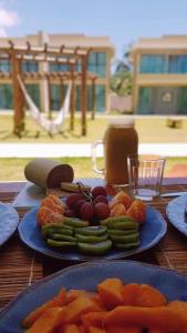a table with two blue plates of fruit and vegetables at Casa Milagres Morada do Toque l até 6 adultos in São Miguel dos Milagres +27 photos