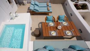 an overhead view of a table and chairs next to a swimming pool at Olea Cave House in Imerovigli