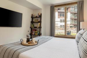 a bedroom with a bed with a tray of food on it at 118 Villa Montane in Avon +47 photos