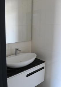 a bathroom with a sink and a mirror on a counter at Queen's Park Hotel in Zatoka +41 photos