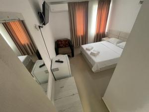 a hotel room with a bed and a mirror at Cazare Pedro in Mamaia +7 photos