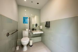 a bathroom with a toilet and a sink at Heart of the city Hostel in Varna City