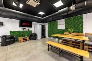 a waiting room with benches and a green wall at Heart of the city Hostel in Varna City