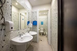 a bathroom with two sinks and a mirror at Heart of the city Hostel in Varna City