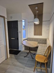 a living room with a couch and a table at Ulverston Town Centre Flat (2 Bedrooms) in Ulverston +3 photos