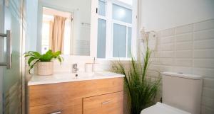 a bathroom with a sink and a toilet and a mirror at Elite Studio - Larios Collection Premium Malaga Center in Málaga