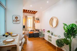 a living room with a table and a couch at Elite Studio - Larios Collection Premium Malaga Center in Málaga