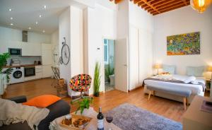 a living room with a bed and a kitchen at Elite Studio - Larios Collection Premium Malaga Center in Málaga