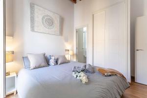 a bedroom with a bed with flowers on it at Top-Class Larios Executive Suite - Malaga Center in Málaga