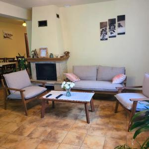 a living room with a couch and a coffee table at Willa Roztocze in Zwierzyniec