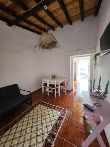a living room with a couch and a table at Campinho Guest house in Campinho
