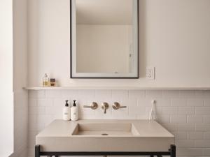a white sink in a bathroom with a mirror at Mint House Washington DC - Downtown in Washington +20 photos