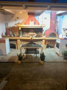 a living room with a table and a fireplace at Sunnyhomes Kryoneri in Mesochórion
