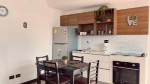 a kitchen with a dining table and a refrigerator at Apartamento Zona 10 in Estación Pamplona