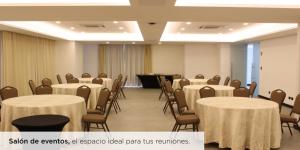 a conference room with tables and chairs and a piano at Apartamento Zona 10 in Estación Pamplona +8 photos