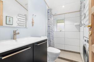 a bathroom with a toilet and a sink and a shower at 1129-Ringkobing-Irisvej-11 in Nørby +37 photos