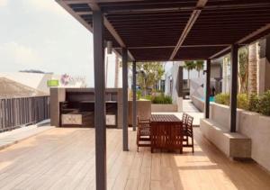 a patio with a table and chairs on a deck at I City Prefect Homestay in Shah Alam