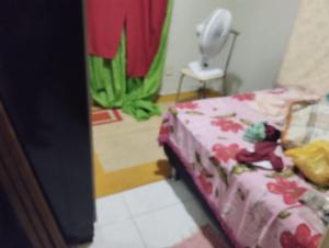 a bedroom with a bed and a plant in a room at Viver Ananindeua in Belém