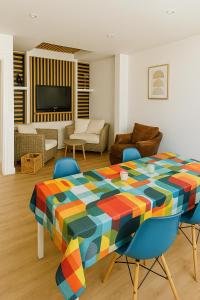 a living room with a colorful table in a room at T4 coeur de ville, à deux pas de la plage - 3 chambres in Saint-Nazaire