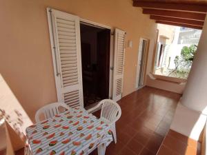 a table and two chairs in a room with a door at Eoliando Case per Vacanze - Lipari Mare in Lipari