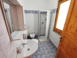 a bathroom with a toilet and a sink and a shower at Eoliando Case per Vacanze - Lipari Mare in Lipari