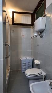 a bathroom with a toilet and a sink at Whole apartment in Villa surrounded by green in Colleverde +64 photos