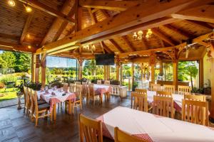 a restaurant with tables and chairs in a pavilion at Restoran Bosiljevo in Bosiljevo