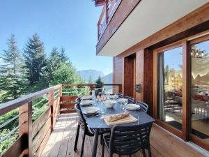 a table on the balcony of a house at Homency - Résidence Parenthese A28 in L'Alpe-d'Huez