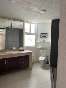 a bathroom with a sink and a toilet in it at Cozy Apartment in Cancun in Cancún +13 photos