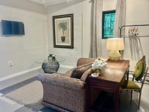 a living room with a couch and a table at Rosebud Cottages in George