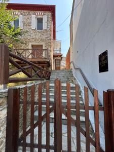 a staircase leading up to a building with a fence at Asteris luxury house in Polygryos