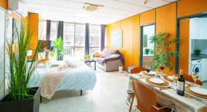 a room with a bed and a table and chairs at Executive Studio Comfort - Malaga Center in Málaga