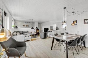 a living room with a table and chairs and a couch at 292-Ringkobing-Vestklitvej-12 in Ringkøbing