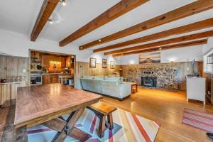 a living room with a table and a fireplace at Tahoe City Gem Pet Friendly Yard Walk to Beach in Tahoe City