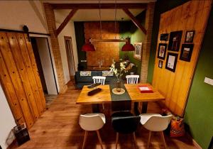 a dining room with a wooden table and chairs at Loft industrial a 45min Playas de Doñana Home Torremirador in Villalba del Alcor +21 photos