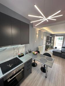 a kitchen with a stove and a table in a room at Asteris luxury house in Polygryos
