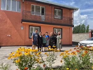 a group of people standing in front of a building at Gulcha in Gultscha