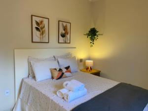 En eller flere senge i et værelse på Recevoir Garden Suítes