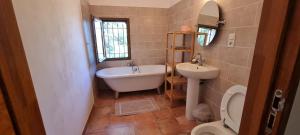 a bathroom with a tub and a sink and a toilet at Malicroix in Arles