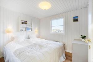 a white bedroom with a large bed and a window at 172-Ringkobing-Magedalen-34 in Ringkøbing