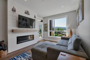 a living room with a couch and a fireplace at Harrison Hot Springs Lakeside in Harrison Hot Springs
