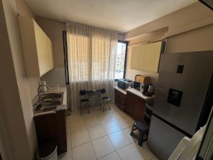a small kitchen with a sink and a microwave at Brand New Apartament Durres in Durrës