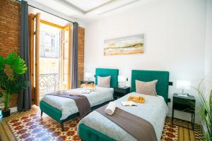 a bedroom with two beds and a balcony at High-End Constitution Plaza Apartment - Malaga Center in Málaga