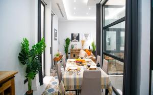 a dining room with a table and a living room at High-End Constitution Plaza Apartment - Malaga Center in Málaga