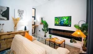 a living room with a couch and a tv at High-End Constitution Plaza Apartment - Malaga Center in Málaga