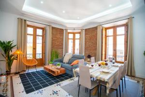 a living room with a couch and a table at Luxury Views Plaza Constitución - Executive Malaga Center in Málaga